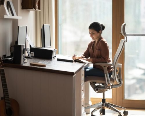 Serious,Young,Indian,Female,Sit,On,Ergonomic,Comfy,Chair,At